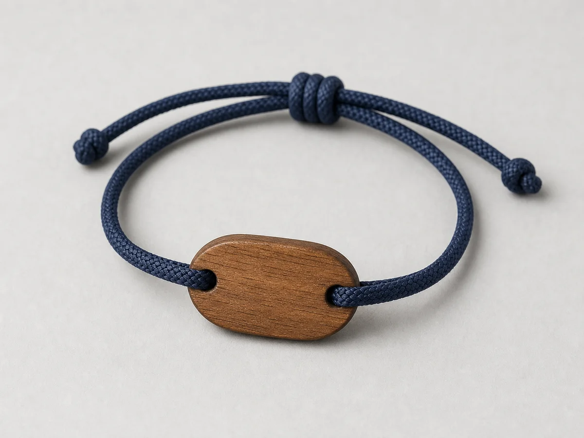 Navy marine-cord RFID wristband with a sealed teak faceplate and sliding adjuster