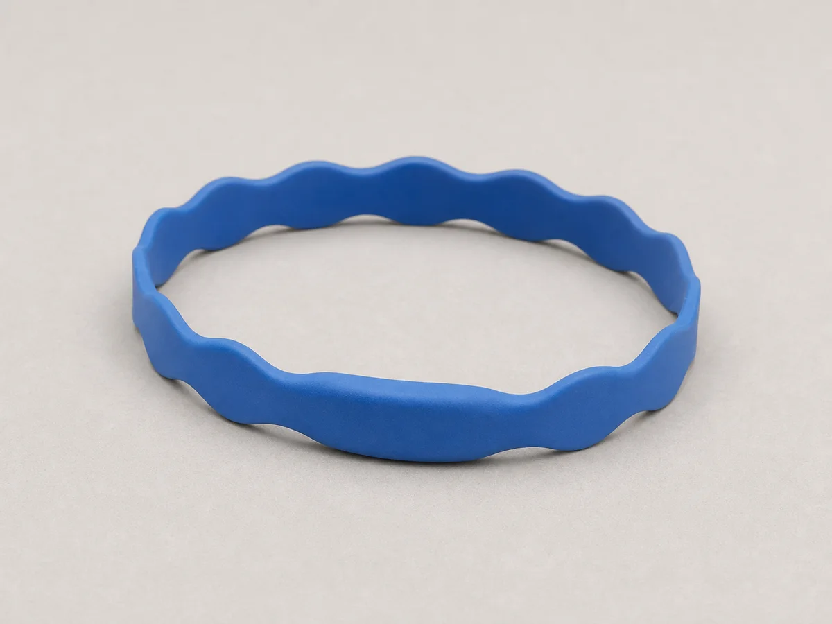 Closure-free blue elastomer RFID wristband with a gentle wavy profile