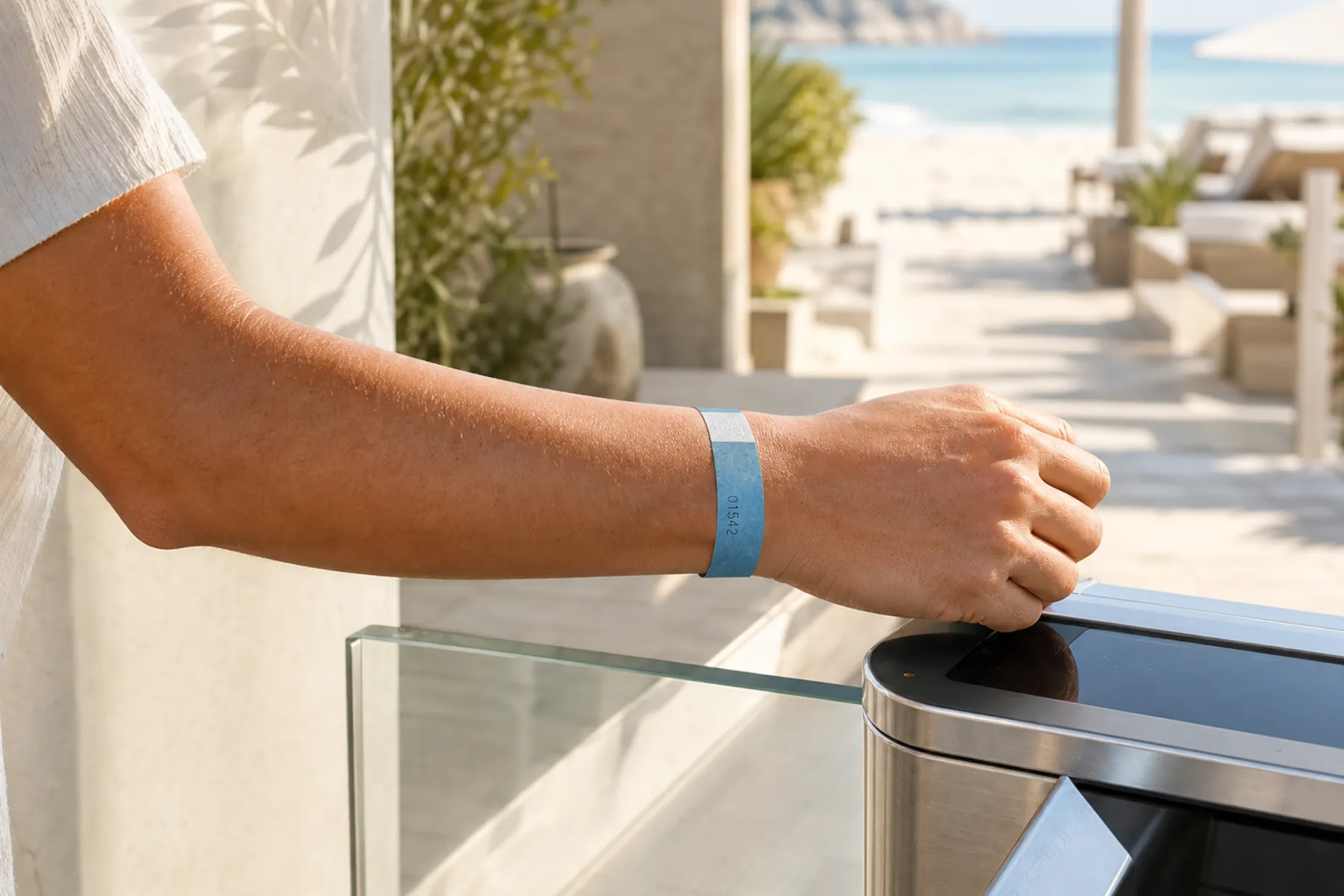 A guest presenting a day-pass wristband at a resort access point