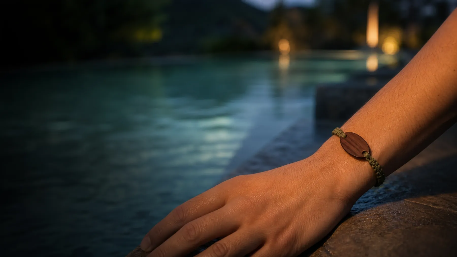 A realistic wood-and-bead RFID wristband worn beside a resort pool